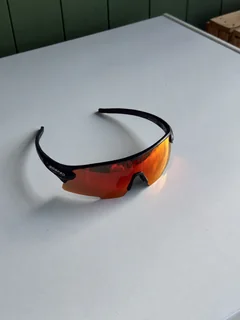 Ember sunglasses on a pale outdoor table, viewed from an angle