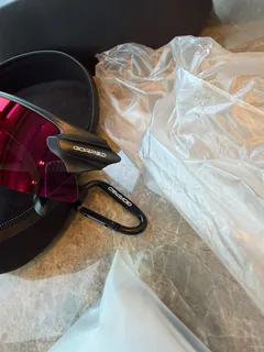 Ember sunglasses with their case and travel pouch on a table